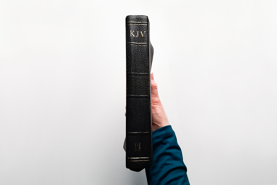 KJV Bible Being Held Up by a Woman's Hand
