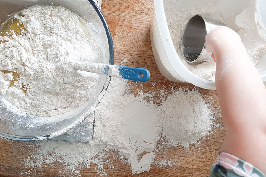 Toddler Helping Measure Flour for Making Bread