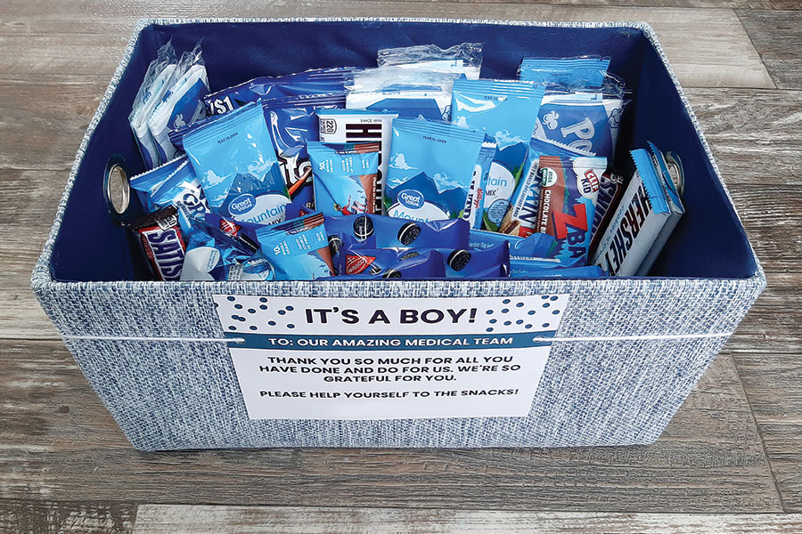 A nurses thank you gift basket filled with blue-colored snacks for a boy-themed snack basket
