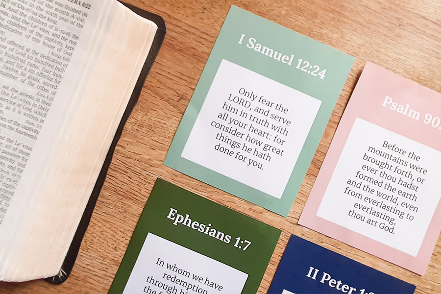 An open KJV Bible with the FREE printable KJV Bible verse cards about the greatness of God
